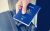 Hands giving passport (of Australia)